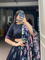 Load image into Gallery viewer, Blue Tussar silk lehenga with floral prints and lace work , Stunning blue lehenga set with gota patti bordered dupatta , Elegant stitched blue lehenga with tassels and lace finish , Blue floral lehenga with zip closure and 3.8m flair , Printed blue lehenga in Tussar silk with unstitched blouse .