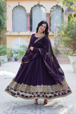 Load image into Gallery viewer, Dark Rani Faux Blooming Anarkali With Price Under 2000 . This Fabric Faux Blooming Dark Rani Grace every occasion with this Gown featuring sequins embroidery, full sleeves, a fancy round neck, and a matching Faux Blooming dupatta. Available Dark Rani Or Purple Or Wine color .