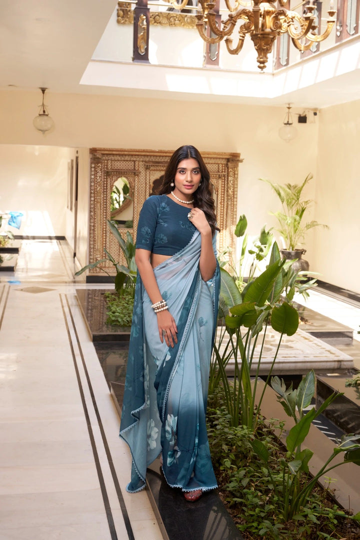Dark sky marble saree with floral prints , Lightweight dark sky blue saree with lace , Trendy floral saree in dark sky color , Soft weightless dark sky saree for casual wear , Elegant printed saree in dark sky tone , Designer dark sky saree with contrast blouse , Floral motif saree in dark sky hue , Dark sky saree with delicate lace border , Festive-ready dark sky printed saree , Subtle dark sky saree for daily use .