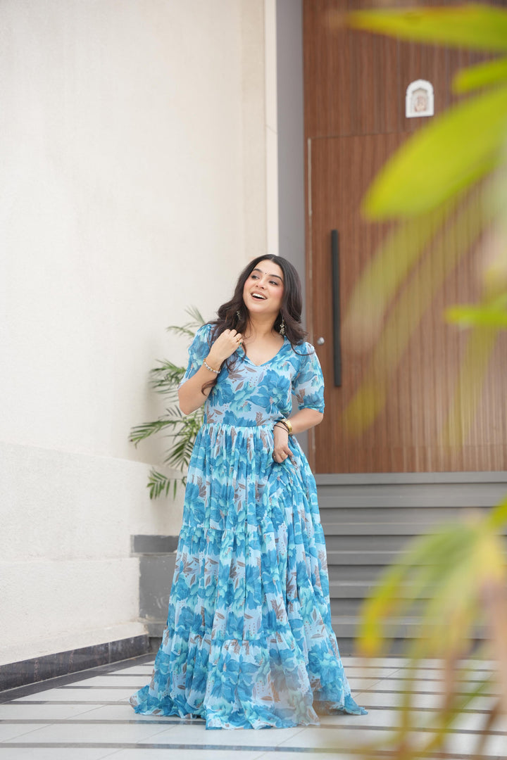 Lightweight sky gown for reception and festive look , Trendy sky blue gown with subtle floral print , Sky color ethnic gown with designer sleeve style , Full flair sky blue gown with rich printed fabric .