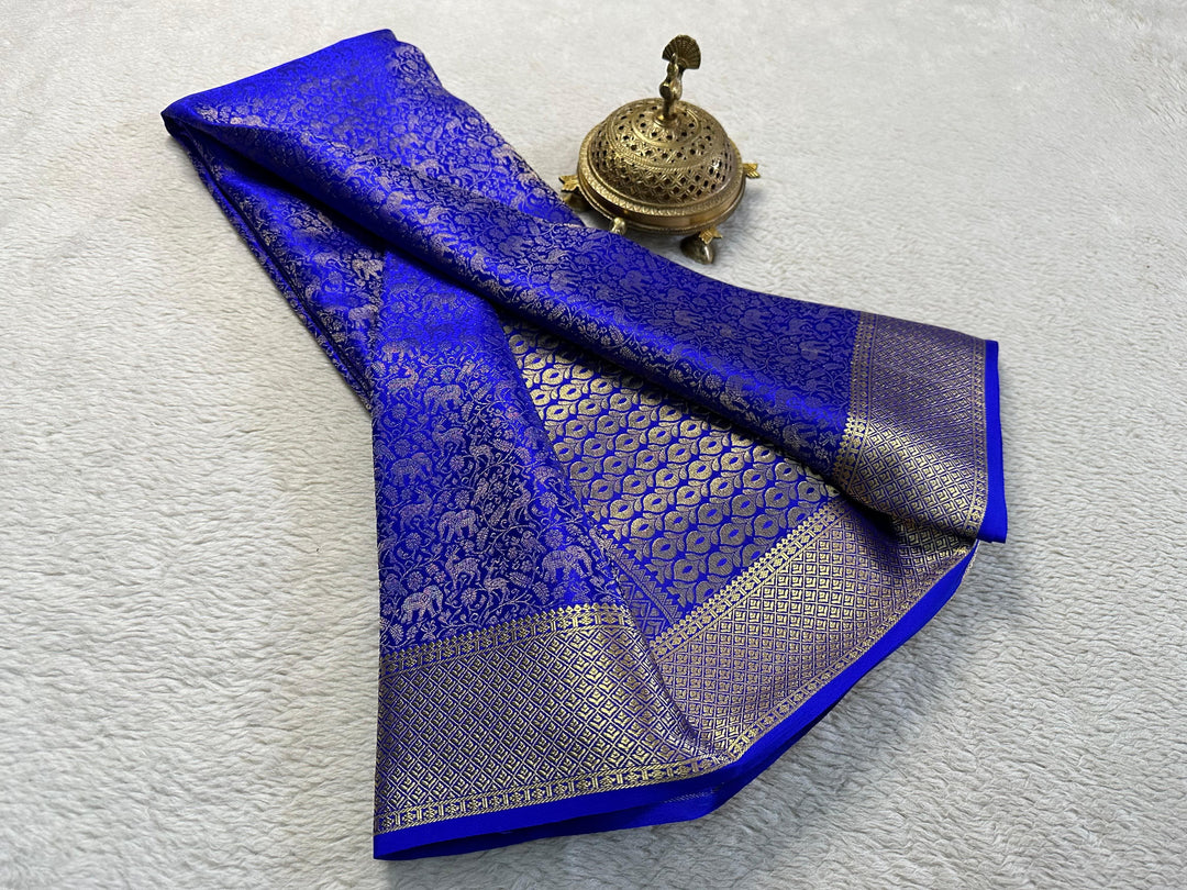 Pure Blue Brocade Mysore Silk Sarees with Price and Online Shopping Price 1500 . This Fabric Made From the fine quality of silk, these sarees are intricately woven with brocade Smooth .