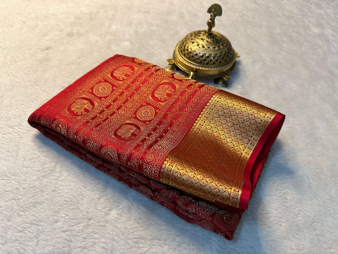 Elegant Red Mysore Silk Saree featuring zari weaving. 6.3m length with matching blouse piece. Machine washable . Fully Zari shown on model Saree .
