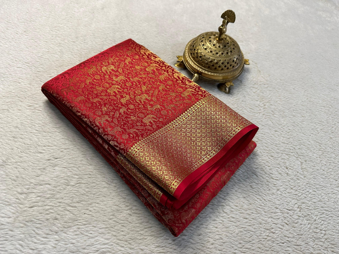 Authentic Red Color Mysore Silk Saree with refined zari detailing. Standard 6.3m length with matching blouse. Machine washable for easy care. Exemplifies traditional silk craftsmanship with modern convenience.