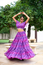 Load image into Gallery viewer, Purple lehenga crafted with comfort and elegance , Fashion-forward purple lehenga in flowy chiffon fabric , Purple beauty lehenga with zip closure and tassel details , Floral print purple lehenga for weddings and occasions .