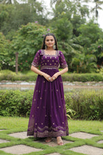 Load image into Gallery viewer, Purple Faux Blooming Gown With Price and Online Shopping Price Under 1500 . this Experience elegance with this Faux Blooming Gown. Complete with exquisite embroidery, short cutwork sleeves, and full cotton lining, it’s a timeless piece for festive or formal occasions . Traditional Look 2024-25 .