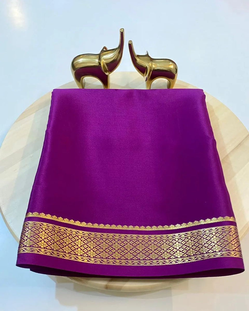 The Hemali Semi-Mysore Silk Saree embodies the perfect fusion of traditional craftsmanship and contemporary wearability. This distinguished garment features premium Semi-Mysore Silk, a fabric renowned for its balanced texture that offers the luxurious appearance of pure silk .