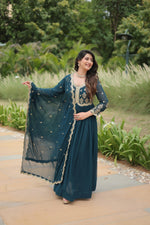 Load image into Gallery viewer, Dark Sky Or Rama Color Faux Blooming Gowns With Price and Online Shopping Price Under 1500 . this fabric Sequins-Multi & Zari Embroidered Work ,Explore elegance with this standard-stitched gown. Sequins and zari embroidery, cotton lining, and a 2.3-meter embroidered lace dupatta included.
