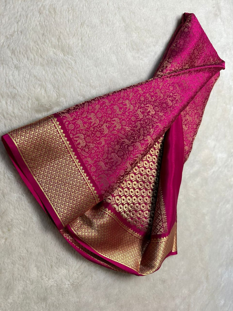 Premium Rani Pink Mysore Silk Saree with intricate zari weaving. 6.3m length, includes matching blouse piece. Machine washable. Perfect blend of traditional craftsmanship and practical elegance.
