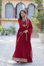 Load image into Gallery viewer, Red Or Maroon Color With Embroidery Faux Blooming Georgette Gown With Price and Online Shopping Price Under 2000 . Step into style with this Maroon Or Red Gown in Faux Blooming Georgette. Featuring heavy Rich Sequins Embroidered work
, a stitched can-can design, and a Faux Blooming Georgette With Attractive lace and embroidered work, it’s ideal for weddings and celebrations .