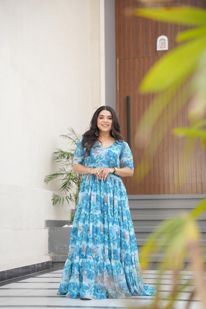 Sky Faux Georgette printed gown with 56-inch length and 12-meter flair. Features half sleeves, fancy V-neck, and full cotton lining. Complete stitched package includes one gown.
