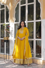 Load image into Gallery viewer, Yellow Faux Blooming Georgette Gown With Prices and Online Shopping Best Price Under 2000 . This Fabric Yellow Faux Blooming Georgette Gown For Haldi War Collection. This Fabric Heavy Embroidery work and Rich ( Premium ) Zari Weaving Work Border and Dupatta Faux Blooming Georgette With Attractive lace and embroidered work . Traditionla Woman Wear Collection Look 2024-25 .