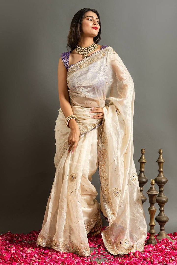 Cream Pure Soft Jimmy Choo Silk Sarees Price and Online Shopping Price Under 2000 . This Fabric Fully Heavy Embroidery Saree and Heavy Border Fully Machine with Purple Blouse Authentic Look 2024-25 . 