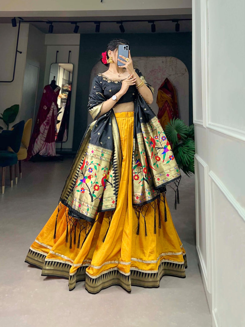 Black Color Blouse with Yellow Color Lehenga With Black Dupatta Heavy Zari Weaving Work , Vichitra Silk Black Langa Davani set includes a stitched lehenga made from Vichitra silk with a Paithani lace border, fitting up to a 42-inch waist with a drawstring and zip closure. The unstitched jacquard silk blouse features handwork and measures 1 meter. The jacquard silk dupatta showcases zari weaving with tassels and is 2.5 meters long. The set offers a complete traditional look with quality fabrics pure . 