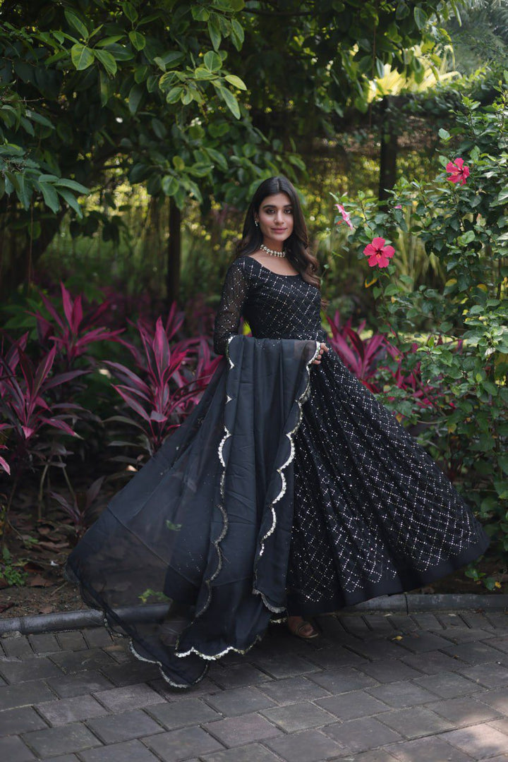 Black Faux Georgette Anarkali Chex Sequins Embroidery and Dupatta With Price and Online Shopping Price Under 2000 . this Fabric Anarkali gown in faux georgette fabric with parallel chex sequins embroidery. Comes with a 2.3-meter silk dupatta and full cotton lining. Available in two elegant colors Black and Purple . 