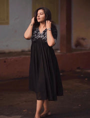 This black Georgette kurti features embroidered details, a V-neck, and half sleeves. It measures 48 inches in length and is machine washable. Available in size S/M/L/XL/2XL.