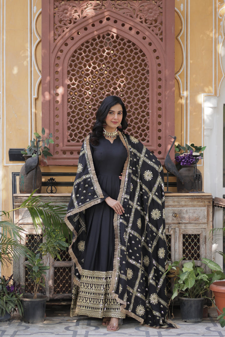 Black embroidered gown with golden sequins , Black star georgette gown for evening wear
Black full sleeve gown with lace dupatta , Elegant black gown for receptions and parties , Black ethnic gown with fancy V-neck . 