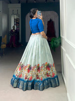 Load image into Gallery viewer, Blue Cotton Silk Dhavani with floral print and Zari border. Pre-stitched lehenga with 3.2m flair and micro cotton inner. Includes fully stitched Banglory blouse with lace border. Professional finishing with handmade tassels and canvas reinforcement.
