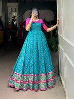 Load image into Gallery viewer, Blue Jacquard Silk Gown With Price and Online Shopping Price Under 2000. this Fabric SO Soft and Silk Fabric and Patola Print With Zari Weaving Work For Fabric Blue Jacquard Silk Gown . Traditional Look and Model Woman Using 2024-25 . This fabric Blue Color Wedding Wear Collection With Price Under 2000 . 
