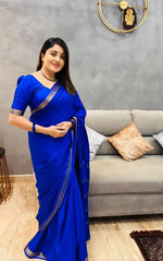 Load image into Gallery viewer, Royal blue silk saree with golden zari border , Elegant navy blue georgette saree with sequins work , 
Sky blue soft silk saree with contrast blouse piece , Traditional blue Banarasi saree for wedding functions , Partywear blue chiffon saree with floral embroidery , Casual wear light blue cotton saree with prints , Designer dark blue saree with lace and beadwork , Classic blue Mysore silk saree with woven pallu , Pure blue organza saree with stone work border , Blue satin saree with digital floral print  
