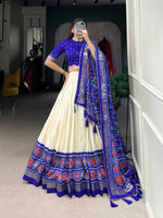 Load image into Gallery viewer, Blue Tussar Silk Dhavani set includes a stitched tussar silk lehenga with Patola print , drawstring waist (fits up to size 42), and zip closure. The lehenga is 42 inches long with 3.8 meters of flair and a micro cotton lining. The unstitched blouse piece is tussar silk with printed design, measuring 0.8 meters. The tussar silk dupatta features Patola print, Gotta Patti lace border, tassels on both sides, and is 2.4 meters long. 
