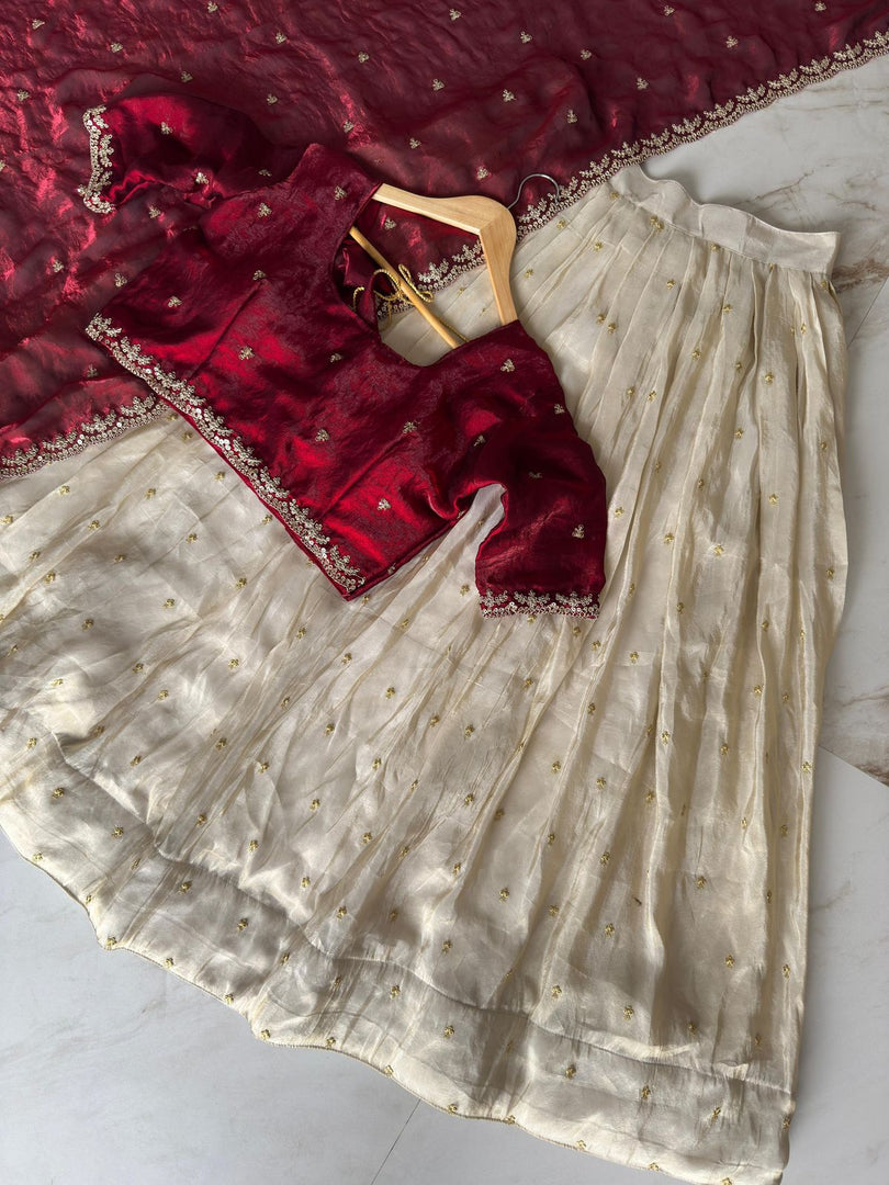 Elegant tissue silk half-saree set with stitched gold zari lehanga (3.5m), unstitched embroidered blouse fabric (0.8m), and decorative voni (2.3m) featuring cut work border.
