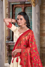 Load image into Gallery viewer, Elegant cream lehenga choli in tussar silk fabric , Cream printed lehenga with foil work and dupatta , Traditional cream lehenga set for wedding events , Cream lehenga with tassel dupatta and lace border . 
