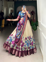 Load image into Gallery viewer, Traditional Dola Silk three-piece set featuring Kalamkari printed stitched lehenga, unstitched blouse, and tasseled dupatta. All pieces crafted from premium jacquard silk with coordinating zari borders.

