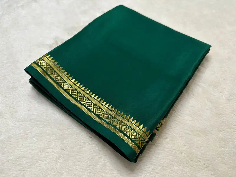 Dark Green Semi-Mysore Silk Saree with zari weaving. 6.3m length. Includes matching blouse. Machine washable. Model wears size S.
