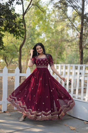 Dark Maroon Faux Blooming Gown With Price and Online Shopping  Price Under 1500 . this Fabric Turn heads with this Faux Blooming Gown featuring elegant zari and sequins embroidery. Designed with a square neck, short cutwork sleeves, and cotton lining, it’s perfect for any special occasion.