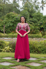 Load image into Gallery viewer, Dark Pink Faux Blooming Gowns with Online Shopping Price Under 1500 . Turn heads with this Faux Blooming Gown featuring elegant zari and sequins embroidery. Designed with a square neck, short cutwork sleeves, and cotton lining, it’s perfect for any special occasion
