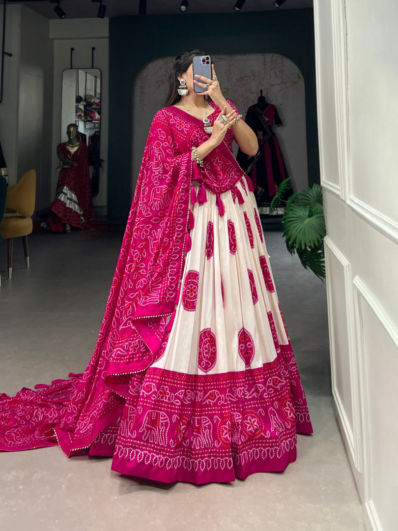Dark Pink Tussar Silk Dhavani Set and Davani Set With Price and Online Shopping Price Under 2000 . Step into elegance with this Tussar Silk Bandhej Print
 Lehenga Set. Complete with lace details, tassels, and a stunning dupatta, this outfit is perfect for weddings and special celebrations Wear....