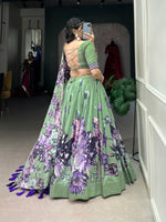 Load image into Gallery viewer, Dark pista Tussar silk lehenga with floral lace details , Beautiful pista green floral lehenga with tassel and can-can finish , Elegant dark pista lehenga with heavy tassels and zari lace , Pista colored Tussar lehenga with gotta patti dupatta, Designer pista lehenga for wedding and engagement looks , Floral print pista lehenga with unstitched blouse fabric . 
