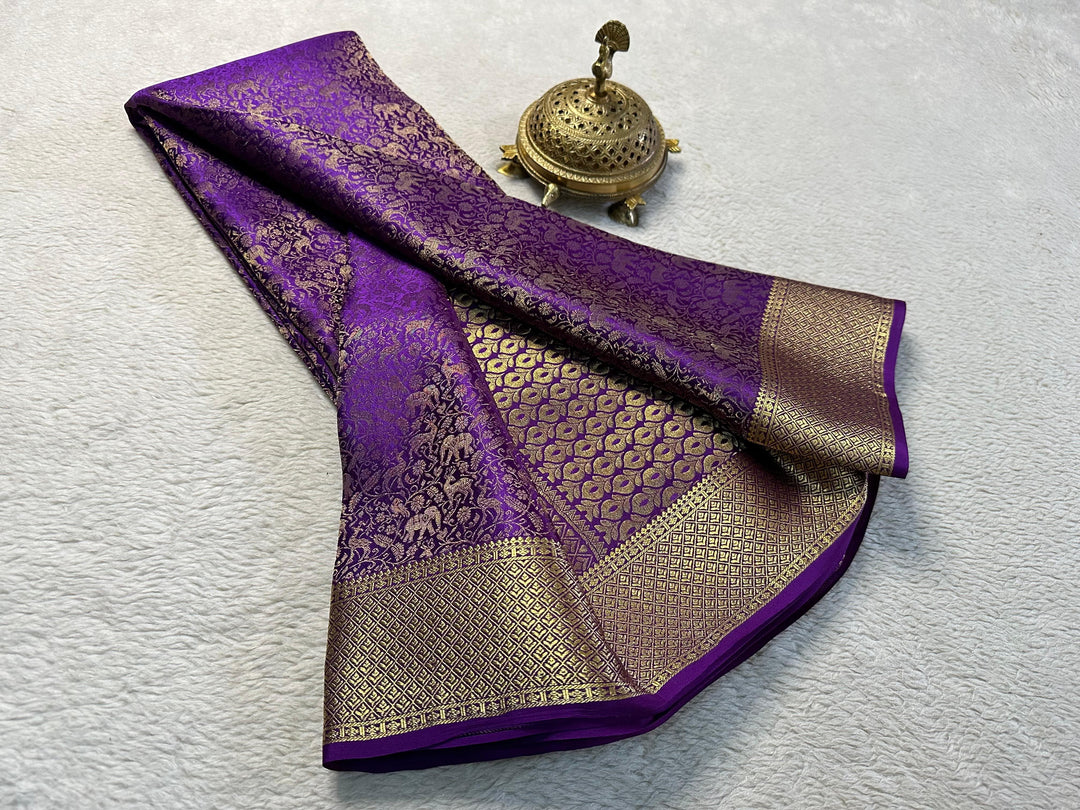 Dark Purple Mysore Silk Sarees WIth Price and Online Shopping Price Under   1500 . This Fabric Most Softness and Smooth Mysore Silk Saree . This Fabric Mysore Silk Saree With Fully Gold Zari Weaving Work and Most Unique Design For Model and Border Small Design Fully Authentic Saree . 