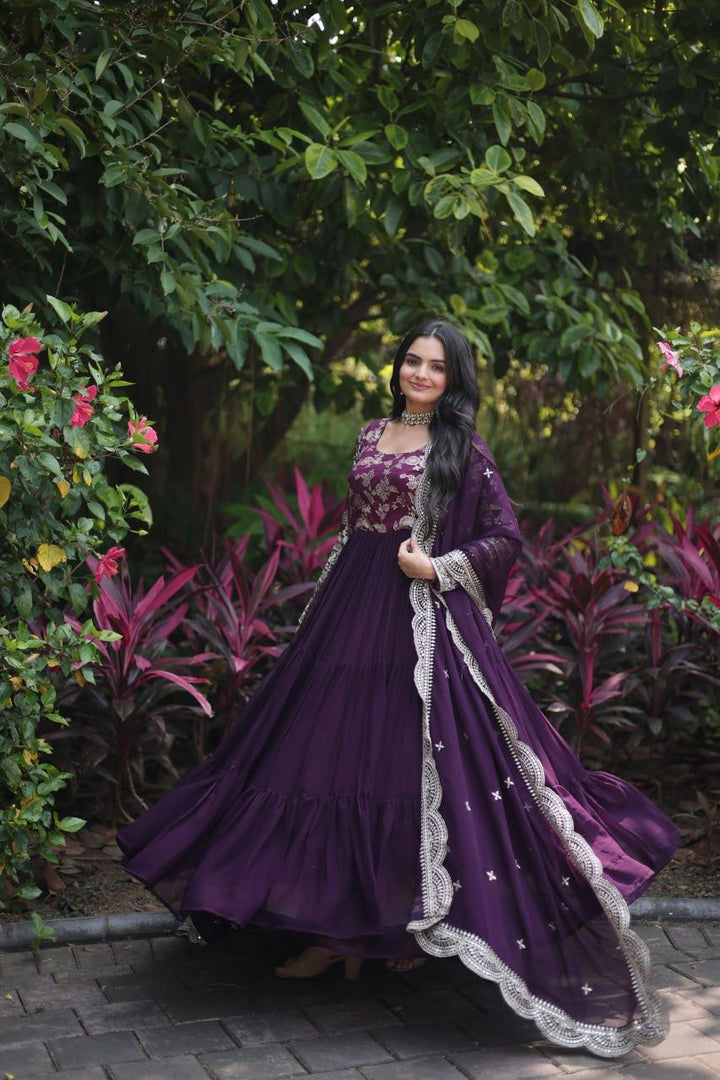 Dark Rani Faux Blooming & Viscose Dyable Jacquard Gowns With Price Under 2000 . This Fabric Faux Blooming & Viscose Dyable Jacquard Dark Rani Grace every occasion with this Viscose Dyable Jacquard Gown featuring sequins embroidery, full sleeves, a fancy round neck, and a matching Faux Blooming dupatta. Available Dark Rani . 