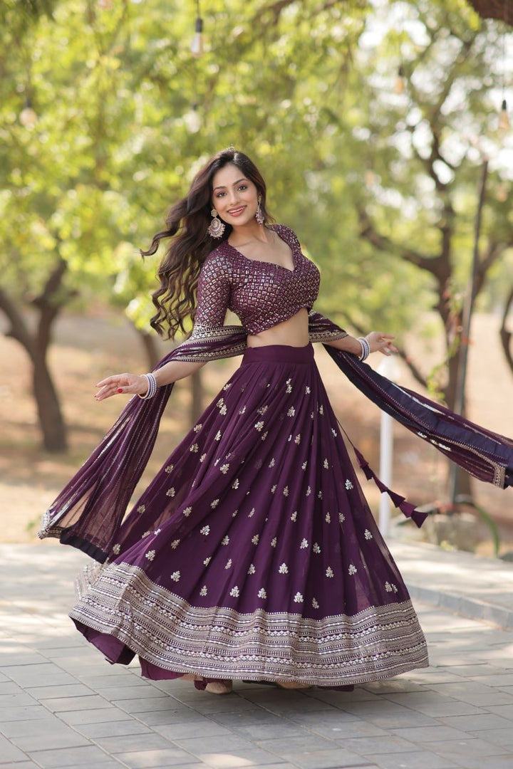 Shop a stunning Dark Purple lehenga set with designer lace dupatta and handcrafted latkans , 
Get a modern ethnic look in this Dark Purple party wear lehenga with 3.5-meter flair , Discover the beauty of traditional design in our Dark Purple embroidered lehenga for women . 