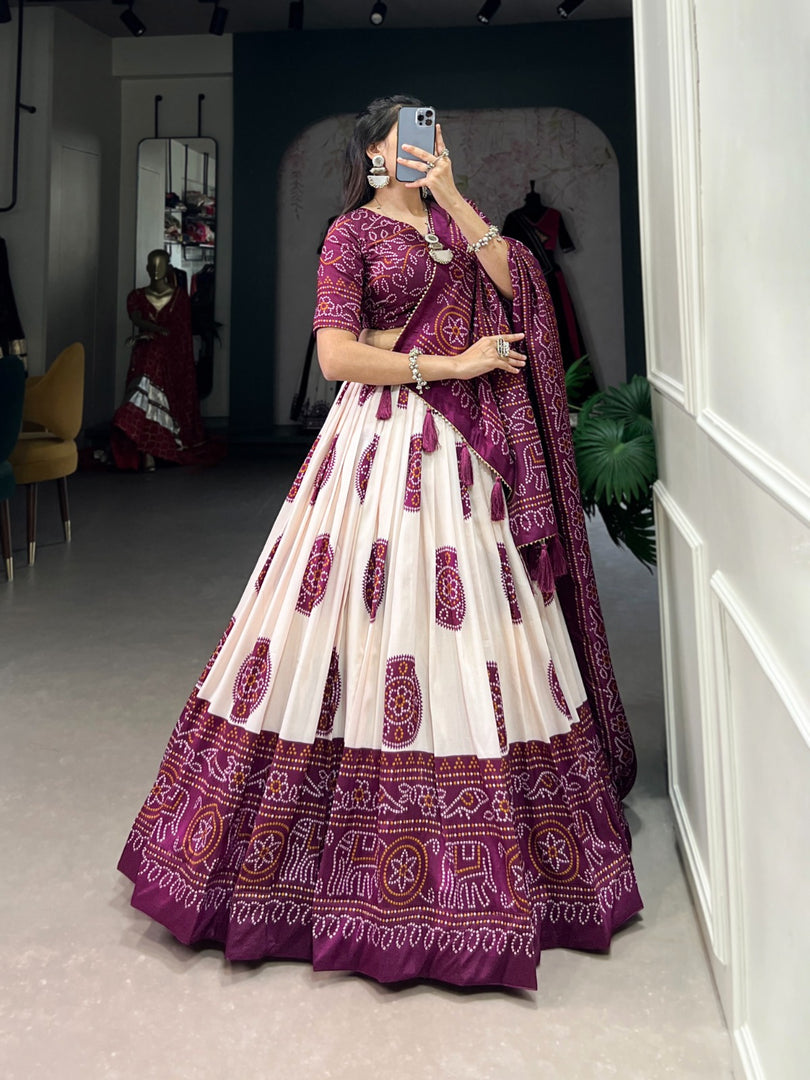 Wine Tussar silk lehenga with handcrafted drawstring closure , Elegant wine color ethnic lehenga for bridal and party wear , Premium wine lehenga with can-can and micro cotton lining , Bandhej printed wine lehenga with zari lace and tassel dupatta . 