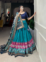 Load image into Gallery viewer, Complete tussar silk dhavani set featuring patola print with foil work. Includes stitched lehenga with can-can (fits up to 42&quot; waist), unstitched blouse, and decorated dupatta with gotta patti border. Designed for elegant drape with premium comfort features.

