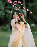 Load image into Gallery viewer, Soft organza Onam Saree featuring check pattern with zari border. 6.3M length with puff half-sleeve design. Machine washable. Single gown piece included.

