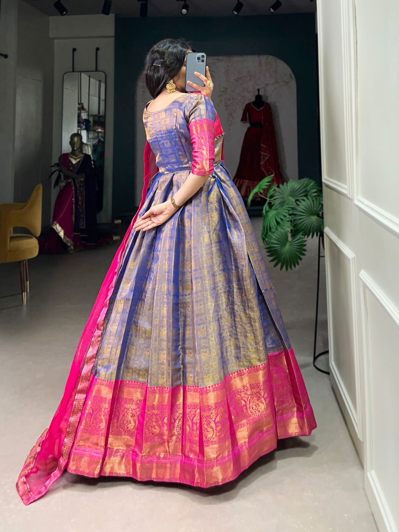 stitched Mansi Kanjivaram Anarkali gown is made from Kanjivaram fabric with intricate zari weaving. It features a 40" chest with an extra 2-inch margin for comfort and a 56" length with 3.5 meters of flair. The gown has full silk lining and 13" sleeves. The net dupatta is plain with a lace border and measures 2.4 meters in length.