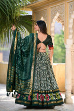 Load image into Gallery viewer, This elegant half saree set features a stitched lehenga made from tussar silk with ikkat print and foil work, supported up to a 42-inch waist, and includes a drawstring with heavy tassels and zip closure -  Shop Now at Shoppers Trend .  
