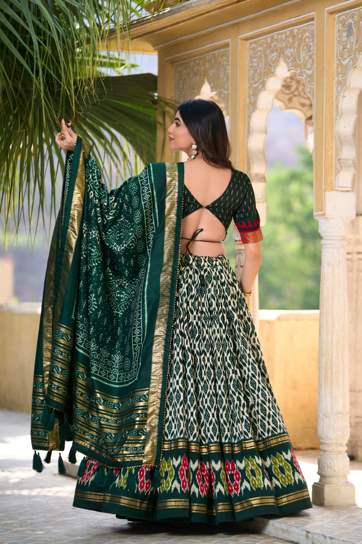 This elegant half saree set features a stitched lehenga made from tussar silk with ikkat print and foil work, supported up to a 42-inch waist, and includes a drawstring with heavy tassels and zip closure -  Shop Now at Shoppers Trend .  
