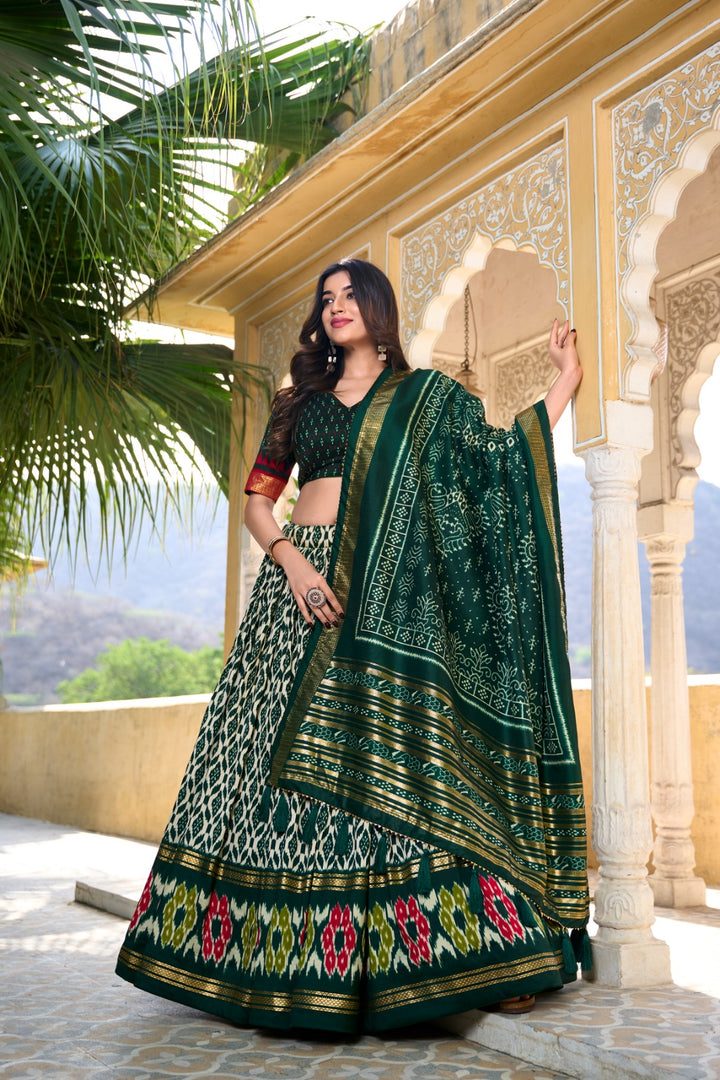 Green foil print lehenga in traditional tussar silk , Wedding special green lehenga with ikkat motifs , Trending green lehenga with shimmer and lace border , Luxurious green lehenga with embroidery-style foil print , Classic green lehenga choli for bridal and celebration wear . 