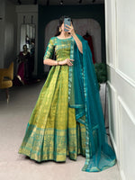 Load image into Gallery viewer, Traditional green Kanjivaram gown with zari work , Emerald green gown with net dupatta and lace , Stylish green silk gown for weddings and events , Kanjivaram ethnic green gown with embroidery , Green color gown for festive Indian wear , Deep green silk gown with lace border dupatta .
