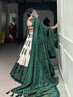 Load image into Gallery viewer, Green Bandhej lehenga with handcrafted tassels and canvas , Elegant green tussar silk lehenga with gotta patti lace dupatta , Traditional green color Bandhej print lehenga for weddings , Vibrant green lehenga with soft inner and can-can stitching . 
