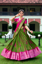 Load image into Gallery viewer, Green Dola Silk Dhavani Set , Half-saree Explore the timeless charm of the Green Dola Silk Dhavani Set. Featuring a soft sheen, vibrant hues, and a classic design, this half saree is ideal for cultural celebrations and traditional events Look Most Trading 2024-25.

