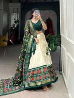 Load image into Gallery viewer, Green Tussar Silk Dhavani Set | Langa Voni , Half-Saree and Davani Set With Price and Online Shopping Price Under 2000 . Step into elegance with this Tussar Silk Patola Print Lehenga Set. Complete with lace details, tassels, and a stunning dupatta, this outfit is perfect for weddings and special celebrations...

