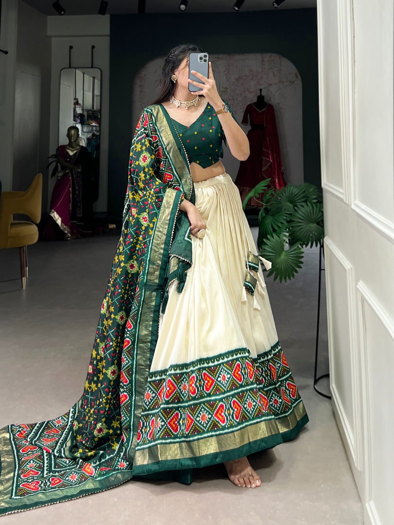 Green Tussar Silk Dhavani Set | Langa Voni , Half-Saree and Davani Set With Price and Online Shopping Price Under 2000 . Step into elegance with this Tussar Silk Patola Print Lehenga Set. Complete with lace details, tassels, and a stunning dupatta, this outfit is perfect for weddings and special celebrations...