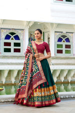Load image into Gallery viewer, Green With Dark Maroon Tussar Silk Dhavani Set , Davani Set and Half-Saree With Price and Online Shopping Price Under 2000 . This Patola Print Dhavani Set features foil printing and a drawstring with heavy tassels and zip. The set also includes a stitched canvas and attached Can , an unstitched blouse with foil printing, a Dupatta, and a Gotta Patti Lace Border with tassels . 
