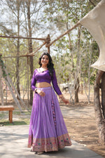 Load image into Gallery viewer, Lavender ethnic lehenga with cotton inner comfort , Traditional lavender lehenga with Jari Kalamkari design , Lavender lehenga with phantom blouse and V-neck design , Zari-bordered lavender lehenga with 3.5 meter flair .
