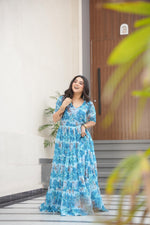 Load image into Gallery viewer, Lightweight sky gown for reception and festive look , Trendy sky blue gown with subtle floral print , Sky color ethnic gown with designer sleeve style , Full flair sky blue gown with rich printed fabric .
